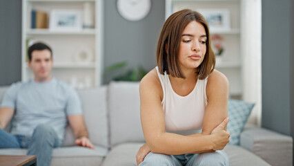 Obraz premium Beautiful couple sitting on sofa arguing at home