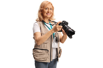 Female jounalist holding a camera and smiling