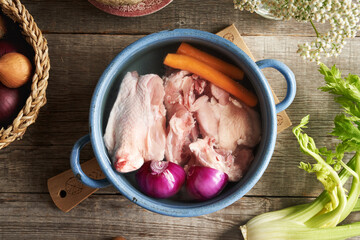 Ingredients for homemade bone broth - chicken meat and fresh vegetables