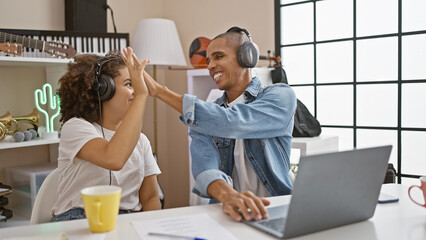 Spirited musicians high five while presenting radio news, headphones on in vibrant studio setting
