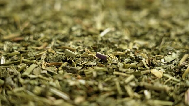 Passiflora organic dry leaves for relaxation. Dried Passion flower herbs falling in slow motion close up. Rotation