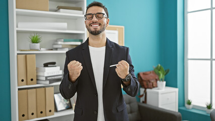 Young arab man business worker smiling confident celebrating at the office