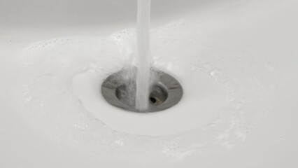 Foamy toothpaste falling from mouth into bathroom sink into splashing running water while brushing teeths. Daily dental hygiene routine - Powered by Adobe