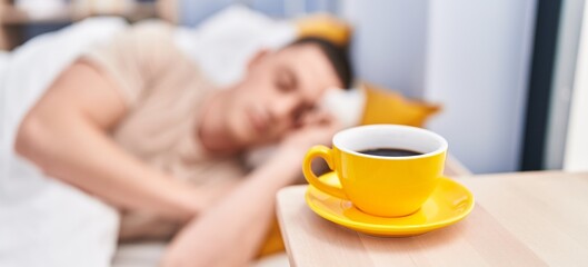 Young hispanic man lying on bed sleeping at bedroom