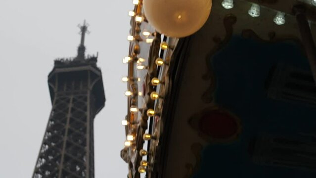 Carousel spinning at the foot of the Eiffel Tower in Paris