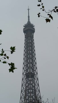 The top of the Eiffel Tower by a cloudy black and white winter day in Paris