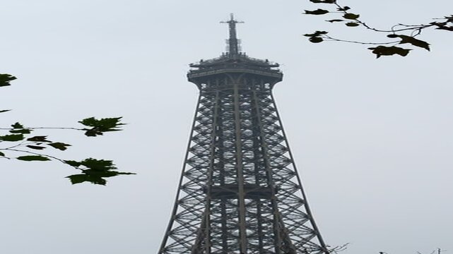 The top of the Eiffel Tower by a cloudy black and white winter day in Paris