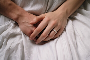 An intimate close-up of a male and female hand holding each other, symbolizing love and togetherness.