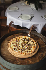 Freshly baked pizza with mushrooms on a dark background.
