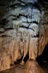 Bear Cave, amazing view of stalactites and stalagnites in colorful bright light, beautiful natural...