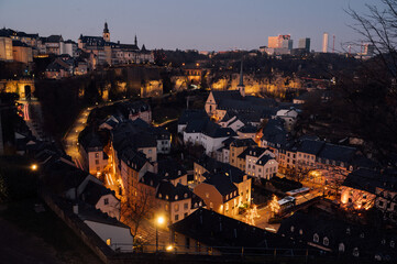 Night view of the picturesque old quarter of Luxembourg City with illuminated streets and historic buildings.
