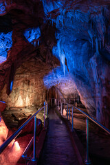 Bear Cave, amazing view of stalactites and stalagnites in colorful bright light, beautiful natural landmark in touristic place.in the Sudeten Mountains. Poland