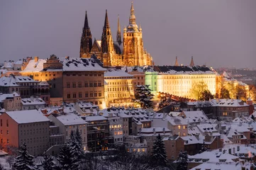 Selbstklebende Fototapeten Snowy twilight captures the Prague Castle amid the winter glow. Prague, Czech Republic  © dvv1989