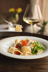 Appetizing pasta, ravioli with red caviar. Italian food, food photography.