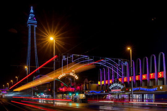 Blackpool, Lancashire, United Kingdom. November 22nd 2023. Blackpool sea front and promenade at night with illuminations and neon lights and a moving tram. Holiday resort in Lancashire England. 