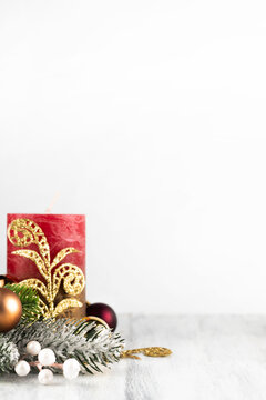 Blurred image of a red Christmas candle and decor on a light background. Christmas background with place for writing text.