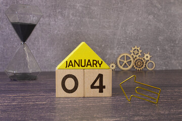 January 4 calendar date text on wooden blocks with blurred background park. Copy space and calendar...