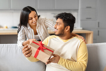 Loving indian wife surprising her husband with gift at home