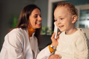 Portrait of a little boy smiling during doctor's visit at home.