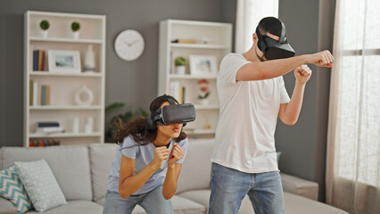 Beautiful couple uniting in love, playing exhilarating boxing video game indoors, using futuristic...