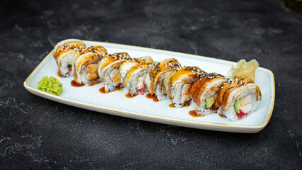 Sushi with wasabi and ginger on a black stone tray on a dark background. Mockup