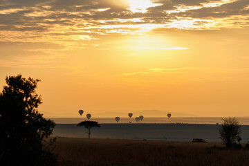 A beautiful landscape photo shot in Masai Mara Kenya, the photo also shows vast dramatic sky and balloon safari in the morning.