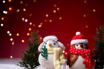 Christmas greeting card background decorated with cute birds and trees.