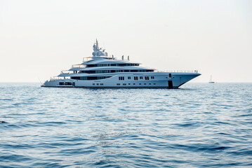 A large luxury private motor yacht under way sailing on the sea
