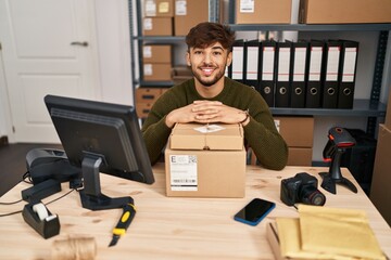 Arab man with beard working at small business ecommerce smiling with a happy and cool smile on...