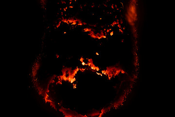 burning paper, glowing edge of paper on a black background