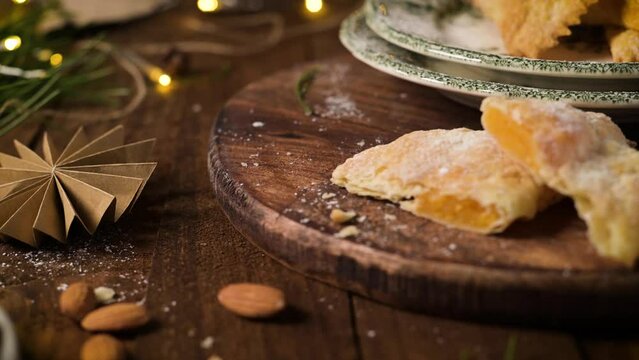 A crescent-shaped pastry whose filling is made of eggs and almonds wrapped in crispy dough, cut in an artisanal way and sprinkled with sugar.