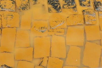 Detail of a stretch of street paved with cobblestones, soiled with mud by flooding from the Pomba River, in the city of Guarani, in the Zona da Mata of the state of Minas Gerais, Brazil.