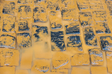 Detail of a stretch of street paved with cobblestones, soiled with mud by flooding from the Pomba River, in the city of Guarani, in the Zona da Mata of the state of Minas Gerais, Brazil.