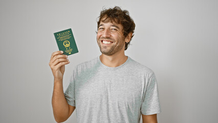 Beaming young man ecstatically waving his macao passport, soaking up happiness on stark white...