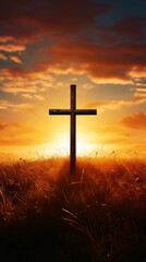 Silhouette Christian cross on grass in sunrise background