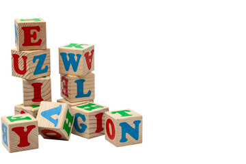 Wooden children's play cubes with blue, red and green letters in the shape of turrets stand one on top of the other and lay side by side. Isolate. © Freemoms_art
