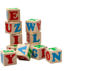 Wooden children's play cubes with blue, red and green letters in the shape of turrets stand one on top of the other and lay side by side. Isolate.