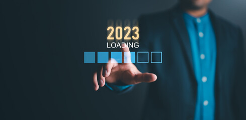 Businessman touching on virtual screen loading bar for 2023 New Year, Start new year 2023 with goal plan, goal concept, action plan, strategy, new year business vision. new start up business.