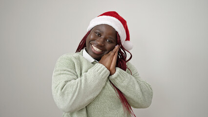 African woman with braided hair smiling confident wearing christmas hat over white background