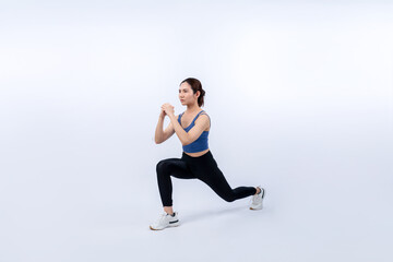 Obraz na płótnie Canvas Young attractive asian woman in sportswear stretching before fitness exercise routine. Healthy body care workout with athletic woman warming up on studio shot isolated background. Vigorous