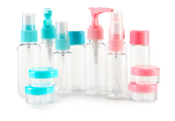 Set of travel cosmetic bottles and jars on white background