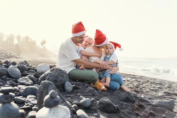 Selbstklebende Fototapete Kanarische Inseln Family portrait on ocean beach. Christmas or New Year vacation.
