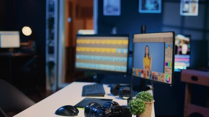 Empty multimedia creative studio with photo editing software on PC display. Industry standard retouching program used by professional photographers left open on computer, dolly in shot