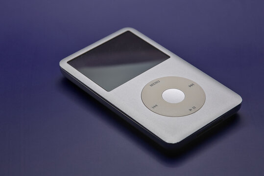 Apple Ipod classic portable mp3 player on a blue background.