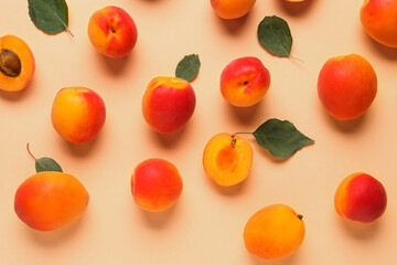 Sweet apricots and leaves on orange background