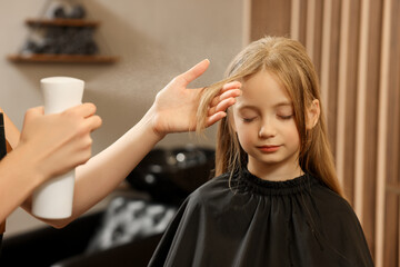 Fototapeta premium Professional hairdresser working with girl in beauty salon
