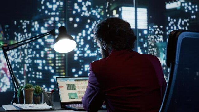 Analyst reviewing authorized financial records and practices for productivity, working at night in sophisticated offices to relieve the administration budget concerns. Stock market business.