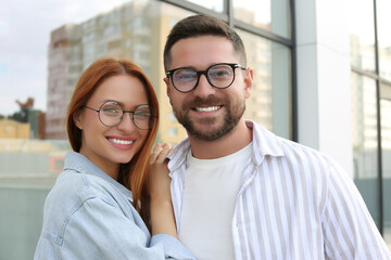 Portrait of happy couple in glasses outdoors - Powered by Adobe