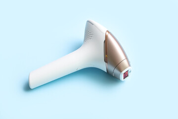 Modern photoepilator on blue background