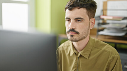 Young hispanic man business worker using computer working at office